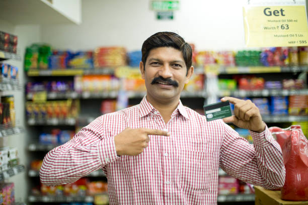 istock Man pointing at credit card in supermarket 1054311346