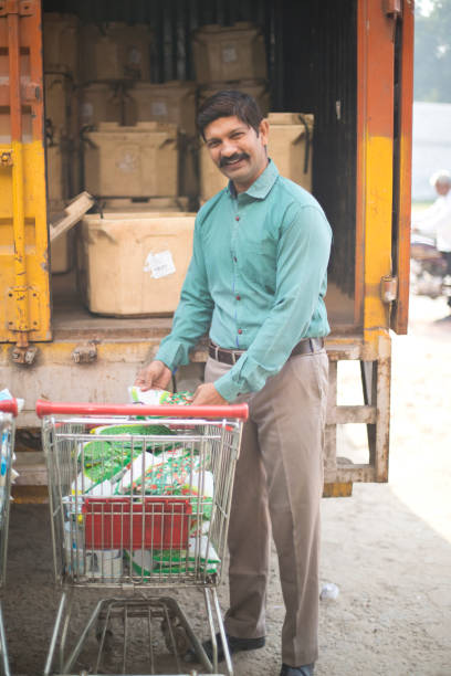 istock Man unloading food packaging from truck 1054311428
