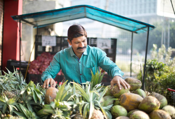 istock Man selling pineapple and coconut 1054311444