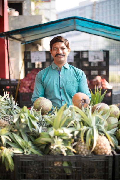 istock Man selling pineapple and coconut 1054316622
