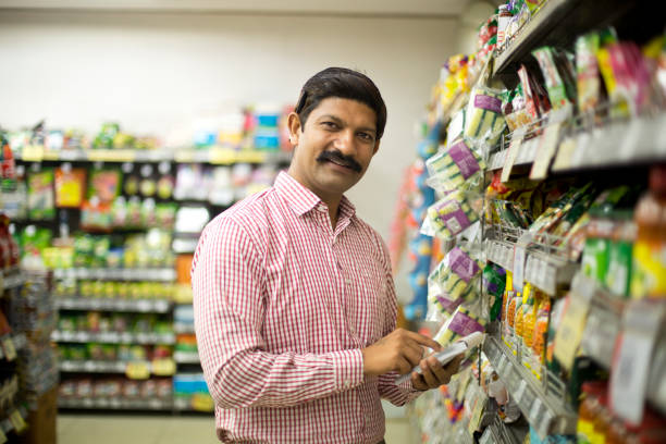istock Man with shopping list in supermarket 1054316782