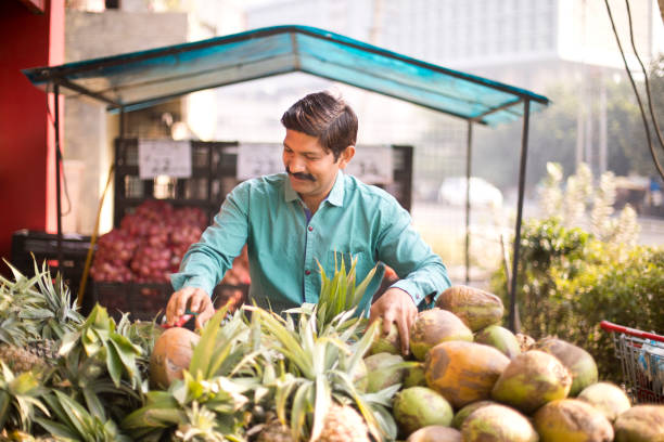 istock Man selling pineapple and coconut 1054317260