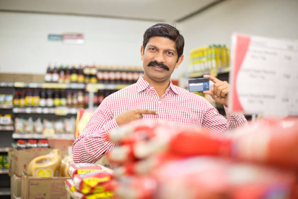 istock Man pointing at credit card in supermarket 1054317292