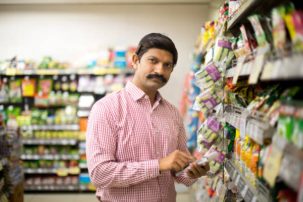 istock Man with shopping list in supermarket 1054317428