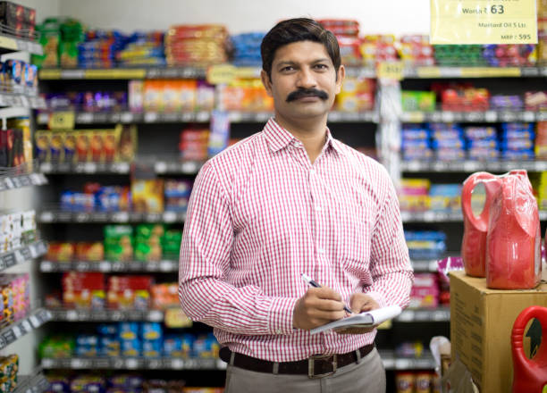 Man in grocery aisle of supermarket with shopping list