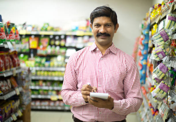 istock Man with shopping list in supermarket 1054317614