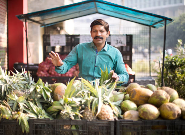 istock Man selling pineapple and coconut 1054317798