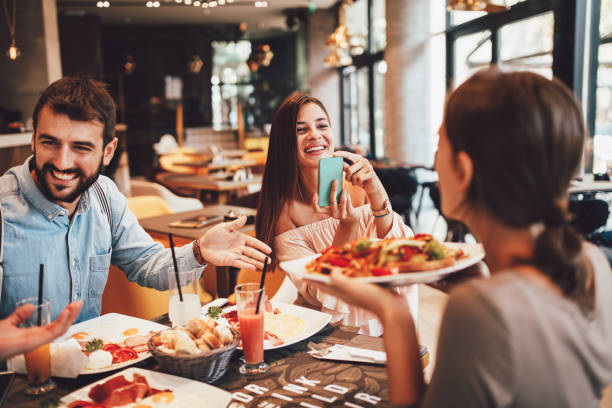 istock Group of Happy friends having breakfast in the restaurant 1054318894