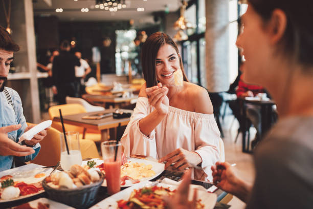istock Group of Happy friends having breakfast in the restaurant 1054322938