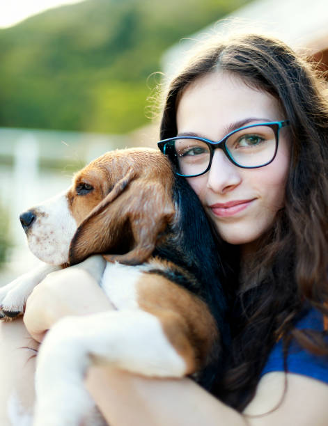 istock Young girl playing with the dog while giving him a bath 1054338312
