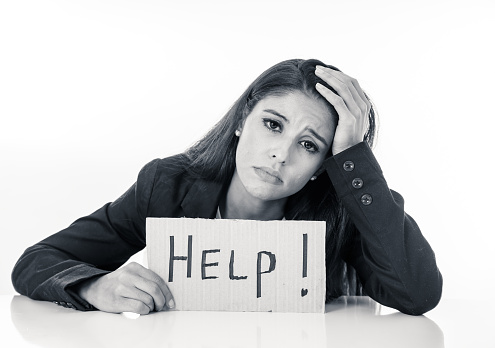 Young beautiful latin business woman overwhelmed and tired holding a help sign. looking Stressed, bored, frustrated, upset and unhappy at work. business frustration concept
