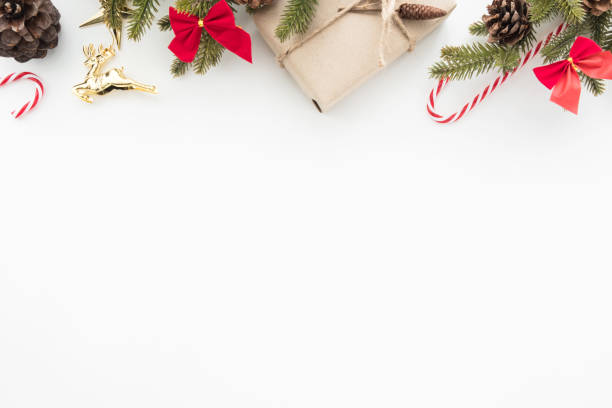 istock Christmas composition background with gift box, candy canes, pine branches with decorations. Top view with copy space, flat lay. 1054350062