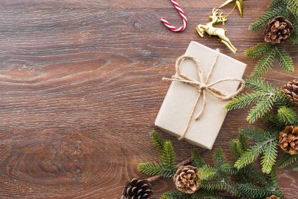istock Christmas composition background on wood table with gift box and some decorations. Top view with copy space, flat lay. 1054350122