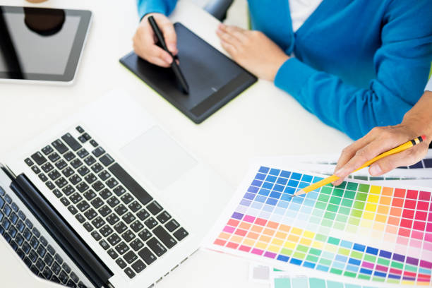 istock Cropped Image Of Fashion Designers Working At Desk While Using Color Swatch And Graphics Tablet At Office 1054351390