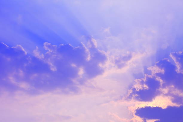 istock Stunning sun light shines through the cloud in a bright blue sky 1054353788