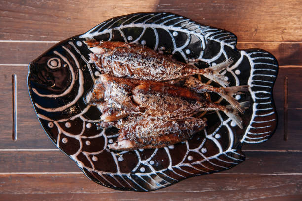 Thai food on dinner table, deep fried crispy makerel fish on beautiful plate