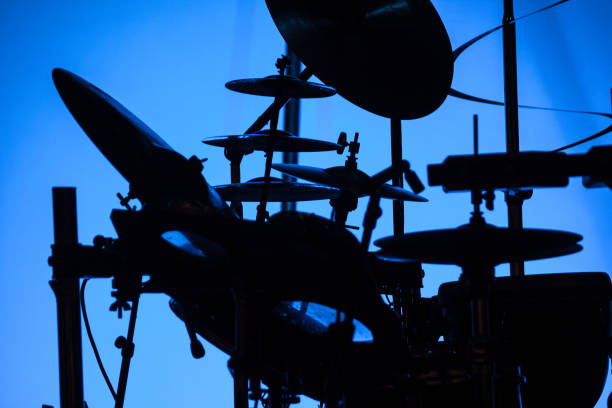 istock Silhouette of a drum set against a blue background light 1054365502