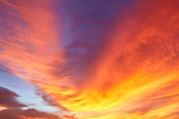 RED Dramatic Sky and Sun Rays Background. Sunbeams Light and Moody Cloudscape. Toned and Filtered Photo with Copy Space