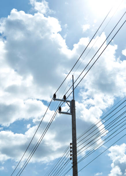 istock Electric Power Transmission With clouds and blue sky 1054369254