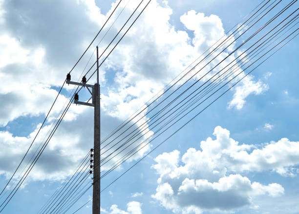 istock Electric Power Transmission With clouds and blue sky 1054369298