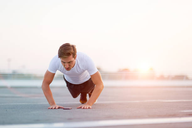 istock Young man exercising outdoors 1054372660