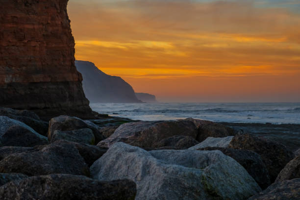 istock Sunset Over Rocky Coastline - North Sea, England, UK 1054377024