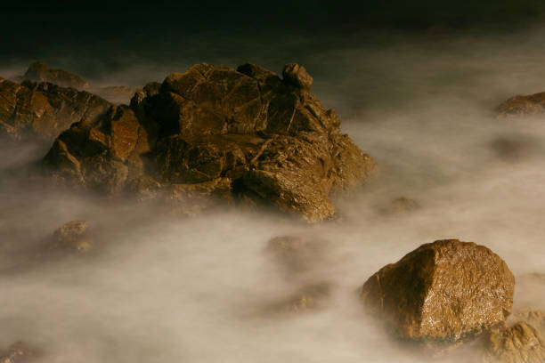 istock Stones on coast at moving sea 1054377190