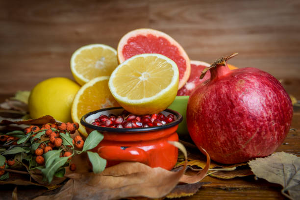 istock Healthy fruits - lemons, oranges, pomegranate, grapefruit, pomegranate seed, slides, autumn leaf 1054379832