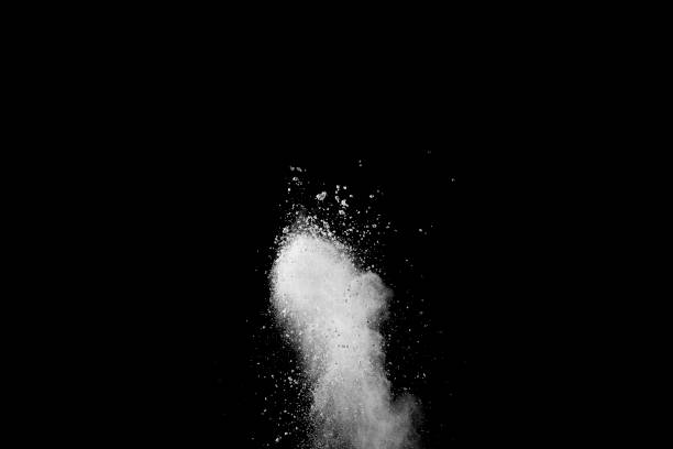 istock Explosion of white dust on black background. 1054385418
