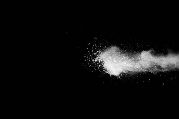 istock Explosion of white dust on black background. 1054385476
