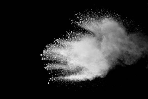 istock Explosion of white dust on black background. 1054386010