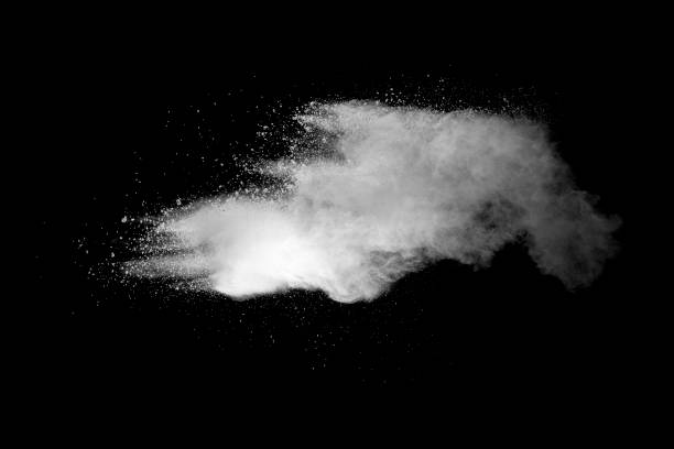 istock Explosion of white dust on black background. 1054386022