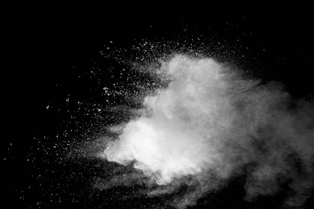 istock Explosion of white dust on black background. 1054386078