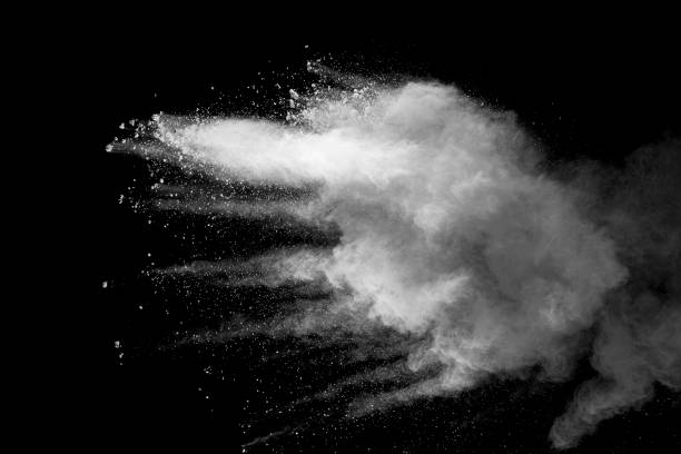 istock Explosion of white dust on black background. 1054386114