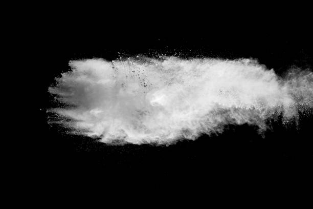 istock Explosion of white dust on black background. 1054386208