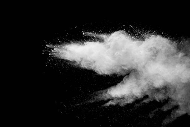 istock Explosion of white dust on black background. 1054386220
