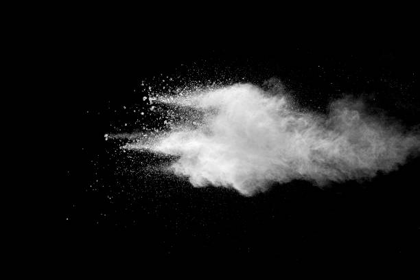 istock Explosion of white dust on black background. 1054386260