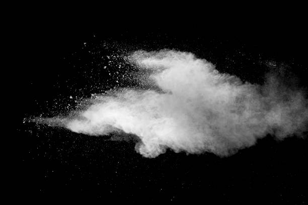 istock Explosion of white dust on black background. 1054386368