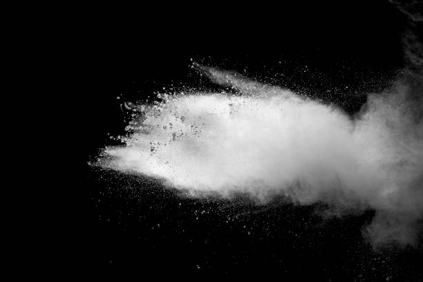 istock Explosion of white dust on black background. 1054386416