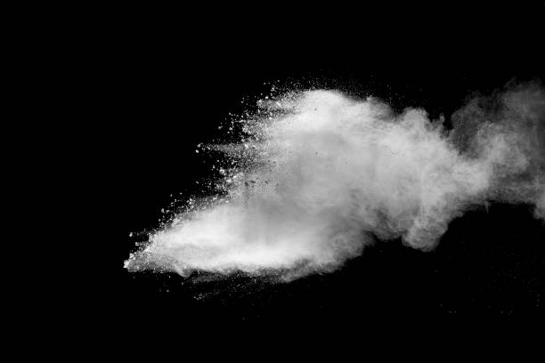 istock Explosion of white dust on black background. 1054386420