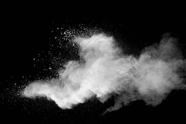 istock Explosion of white dust on black background. 1054386436