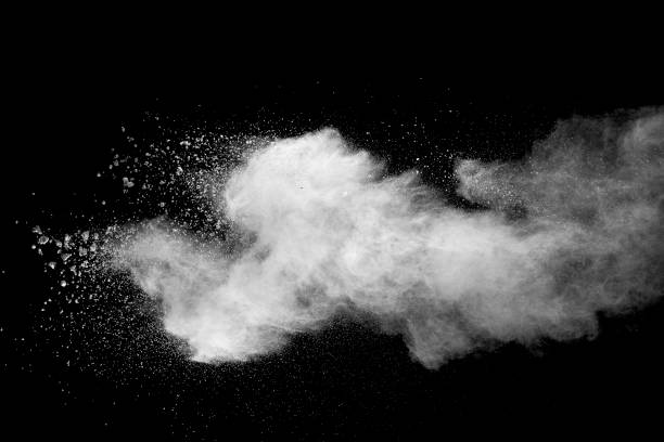 istock Explosion of white dust on black background. 1054386472