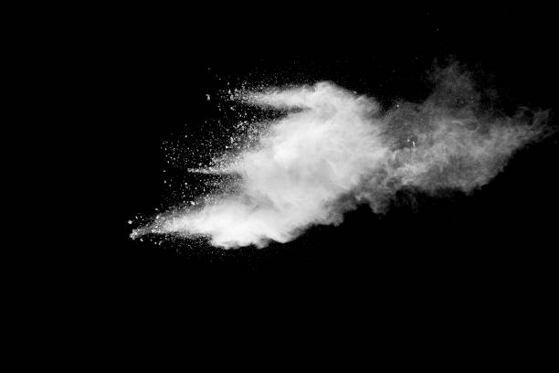 istock Explosion of white dust on black background. 1054386508