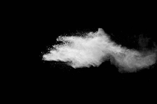 istock Explosion of white dust on black background. 1054386536