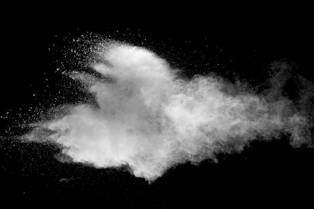 istock Explosion of white dust on black background. 1054386558