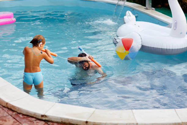 istock Family Water Fight 1054389924