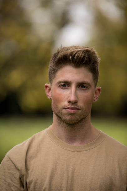 istock Portrait Of Young Man Against Trees 1054392010
