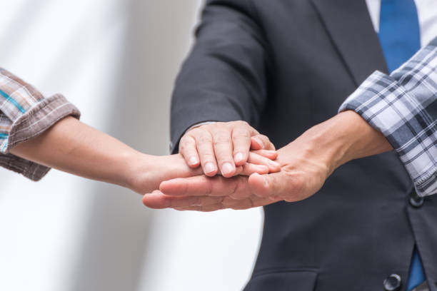 istock Cropped Image Of Business People Stacking Hands 1054392660