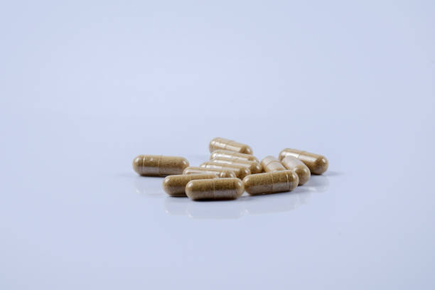 istock Close-Up Of Capsules Over White Background 1054394488