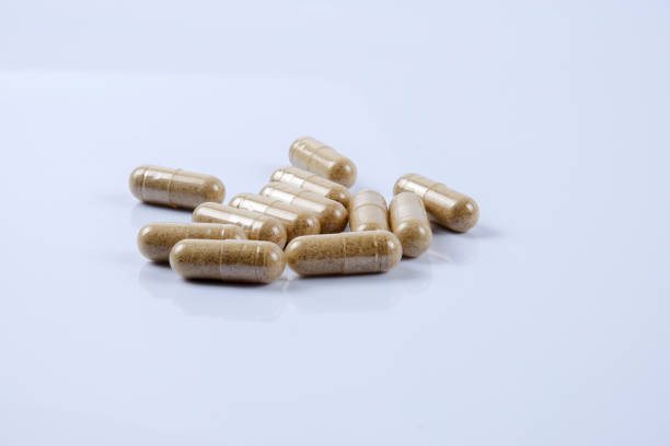 istock Close-Up Of Capsules Over White Background 1054394490